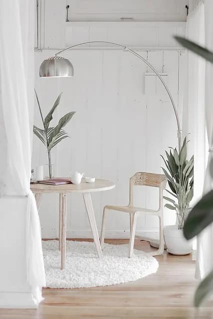 a white room with a round table and a chair